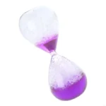 Hourglass with purple liquid and bubbles, demonstrating scientific principles of fluid dynamics and time measurement.