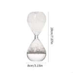Clear glass hourglass timer measuring 8cm by 20cm, used for timing science experiments and educational activities.
