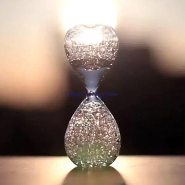 An elegant glass sand timer with fine sand flowing from the top to the bottom chamber, used for time measurement and educational demonstrations.