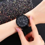 Analog wristwatch with scientific diagram on the dial, worn on a person's wrist.