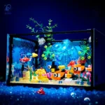 Vibrant LEGO fish swimming among coral and aquatic plants inside a glass aquarium display.