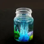 Transparent jar filled with colorful magnetic liquid and magnetic particles creating dynamic patterns inside.