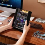 Person holding an interactive science puzzle book with transparent cover, revealing detailed mechanical and electronic components inside, on a wooden desk.