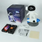Rocket astronaut toy with galaxy projector, light, and accessories for educational and entertainment use. Perfect for science decor and STEM learning activities.