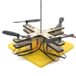 DIY quadcopter drone kit with propellers, electronic components, and base for STEM educational projects and experiments.