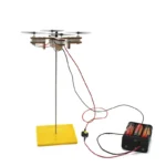 Educational drone experiment with wires and battery pack demonstrating electromagnetic principles for science learning.