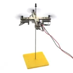 Miniature robotic drone with a yellow base and electronic components for educational experiments.