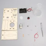 Detailed view of various small parts including a battery holder, motor, glass container, screwdriver, and electronic components.