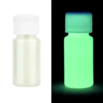 Small white bottle of glow-in-the-dark paint, visible in normal and dark lighting, demonstrating luminous properties for educational and decorative use.
