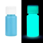 Small blue bottle of glow-in-the-dark paint, shown both in normal light and glowing in the dark, ideal for science experiments and educational projects.