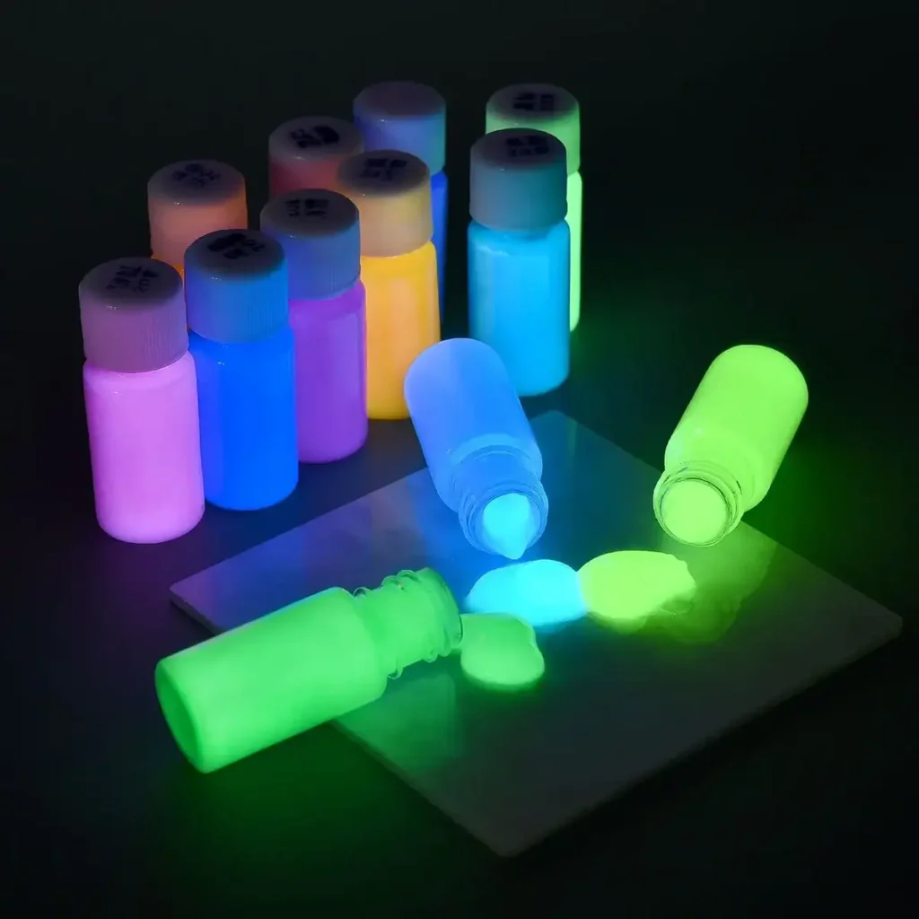 Glow-in-the-dark paint bottles with vibrant colors illuminated under UV light, perfect for educational science projects and creative decor.