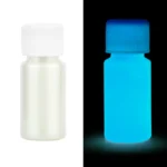 Small white bottle of glow-in-the-dark paint glowing blue in the dark, ideal for science projects and educational toys.