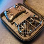 Portable drone controller with detachable propeller guard and compact design, ideal for aerial photography and drone enthusiasts.