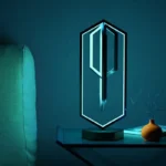 Futuristic LED lamp with geometric design on a modern table.
