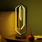 Stylish geometric LED desk lamp with a contemporary design, providing warm ambient light perfect for modern home or office decor.