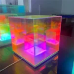A colorful, illuminated LED cube light perfect for science-themed decor and educational settings, featuring vibrant, changing colors and a sleek transparent design.