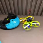 A compact yellow and black quadcopter drone with protective rings, designed for educational and recreational use.