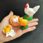 Set of colorful baby chick and hen figurines including a hen, a chick, and an egg nest, ideal for educational toys and science decor.