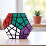 Colorful hexagonal Rubik's Cube puzzle with black frame, featuring green, purple, white, and red sections, placed on a wooden surface with a blurred indoor background.
