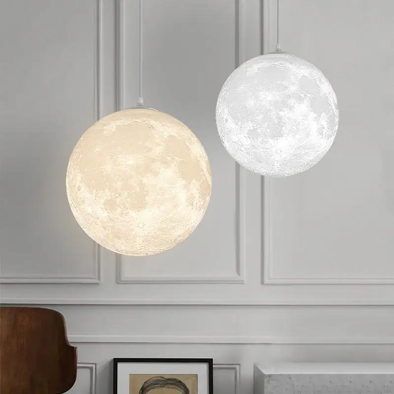 Moon Phase Pendant Lights - Set of 2 Modern moon phase pendant lights with illuminated lunar surface designs, perfect for contemporary home decor and educational spaces.