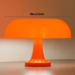 Bright orange mushroom-shaped LED lamp with a modern design, measuring 28cm (11 inches) in width.