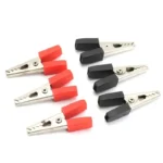 Alligator clips with red and black insulated handles for electrical testing and prototyping.