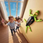 A large, interactive robotic frog mounted on a wall with children excitedly pointing at it in a bright room with a large window.