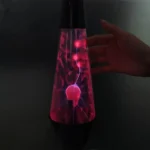 A magnetic plasma lava lamp displaying colorful plasma filaments inside a glass cone, creating a mesmerizing visual effect.