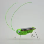 Adorable green grasshopper robot toy with LED eyes, designed for educational purposes and as a unique decor piece. Features movable legs and antennae, perfect for science enthusiasts and kids.