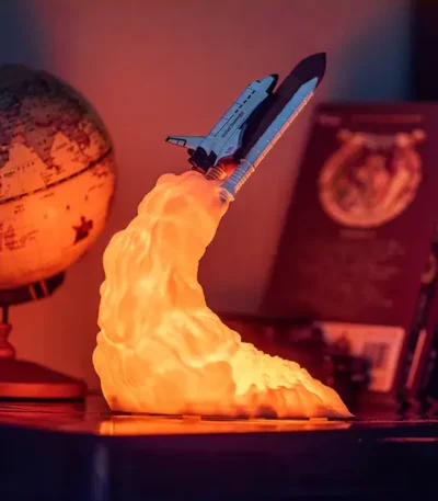 Realistic space shuttle rocket lamp emitting a warm glow, perfect for science-themed decor and educational settings.