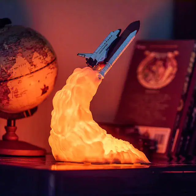 Realistic space shuttle rocket lamp emitting a warm glow, perfect for science-themed decor and educational settings.