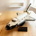 Detailed LEGO space shuttle model with launch pad, showcasing intricate design and realistic features, perfect for science and space enthusiasts.