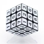 A 3D cube puzzle with numbered sides designed for educational purposes and brain training, featuring a sleek black and white design.