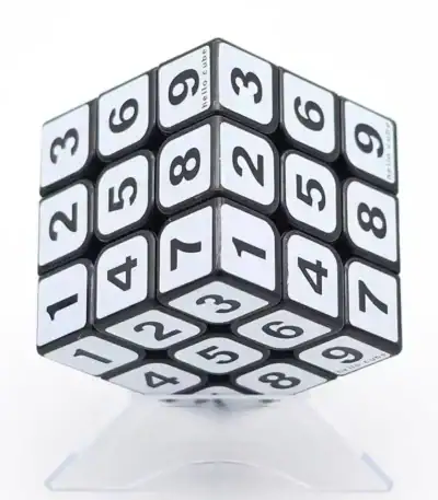 A 3D cube puzzle with numbered sides designed for educational purposes and brain training, featuring a sleek black and white design.