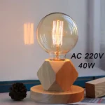 A decorative vintage-style light bulb with an exposed filament, mounted on a geometric wooden base, ideal for science-themed decor and educational displays.