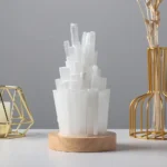 Elegant white crystal geode sculpture on a wooden base, perfect for science-themed decor and educational displays.
