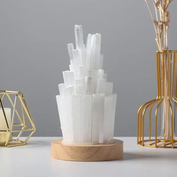 Elegant white crystal geode sculpture on a wooden base, perfect for science-themed decor and educational displays.