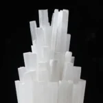 A striking sculpture made of large, transparent salt crystals arranged in a modern, artistic display against a black background.