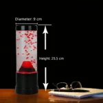 Vortex water tornado in a transparent cylinder with red particles, demonstrating fluid dynamics.
