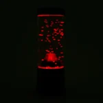 Lava lamp with red liquid and bubbles glowing in the dark, creating a mesmerizing visual effect.