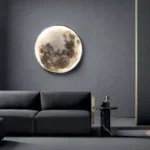 Realistic moon phase wall art illuminated light fixture on a modern living room wall, creating a celestial ambiance.