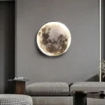Circular moon phase wall art illuminated on a modern gray wall, adding a celestial touch to contemporary interior decor.