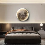 Realistic moon phase wall art above a modern bed, creating a celestial bedroom decor with a glowing lunar design.