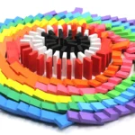 Vibrant rainbow-colored dominoes arranged in a heart shape, perfect for educational activities and decorative displays.