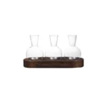Glass laboratory flasks on wooden base for science experiments and decor.