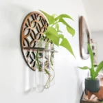 Modern plant wall decor featuring glass vases mounted on a decorative wooden frame, perfect for adding greenery to interior spaces.