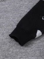 Socks with scientific atom pattern on gray background.