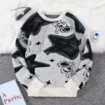 Cozy cartoon dog sweater featuring playful dog illustrations in black, white, and gray, perfect for casual wear and adding fun to your wardrobe.