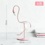 A pink flamingo-shaped desk lamp with a height of 28cm and a width of 16cm, designed for stylish home or office decor and educational purposes.