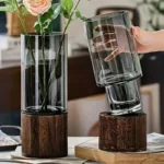 Modern glass vase with a wooden base, perfect for floral arrangements and home decoration.